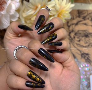 Wearing nails, black and gold court style nail art